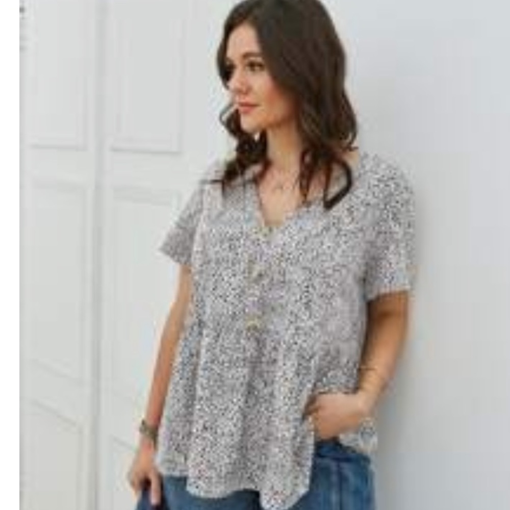 Black and white shirt sleeve top with decorative buttons